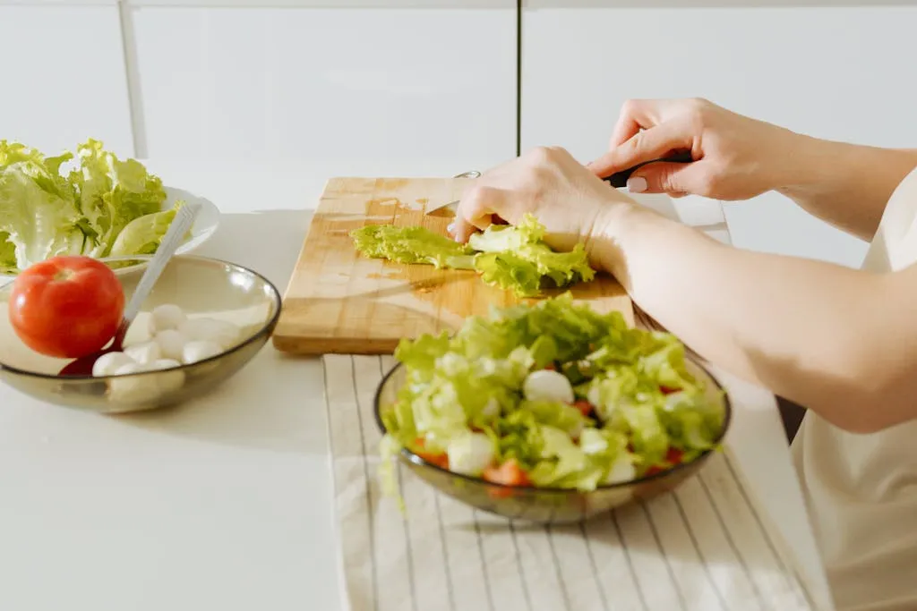 A person preparing vegetables for a low-carb meal.